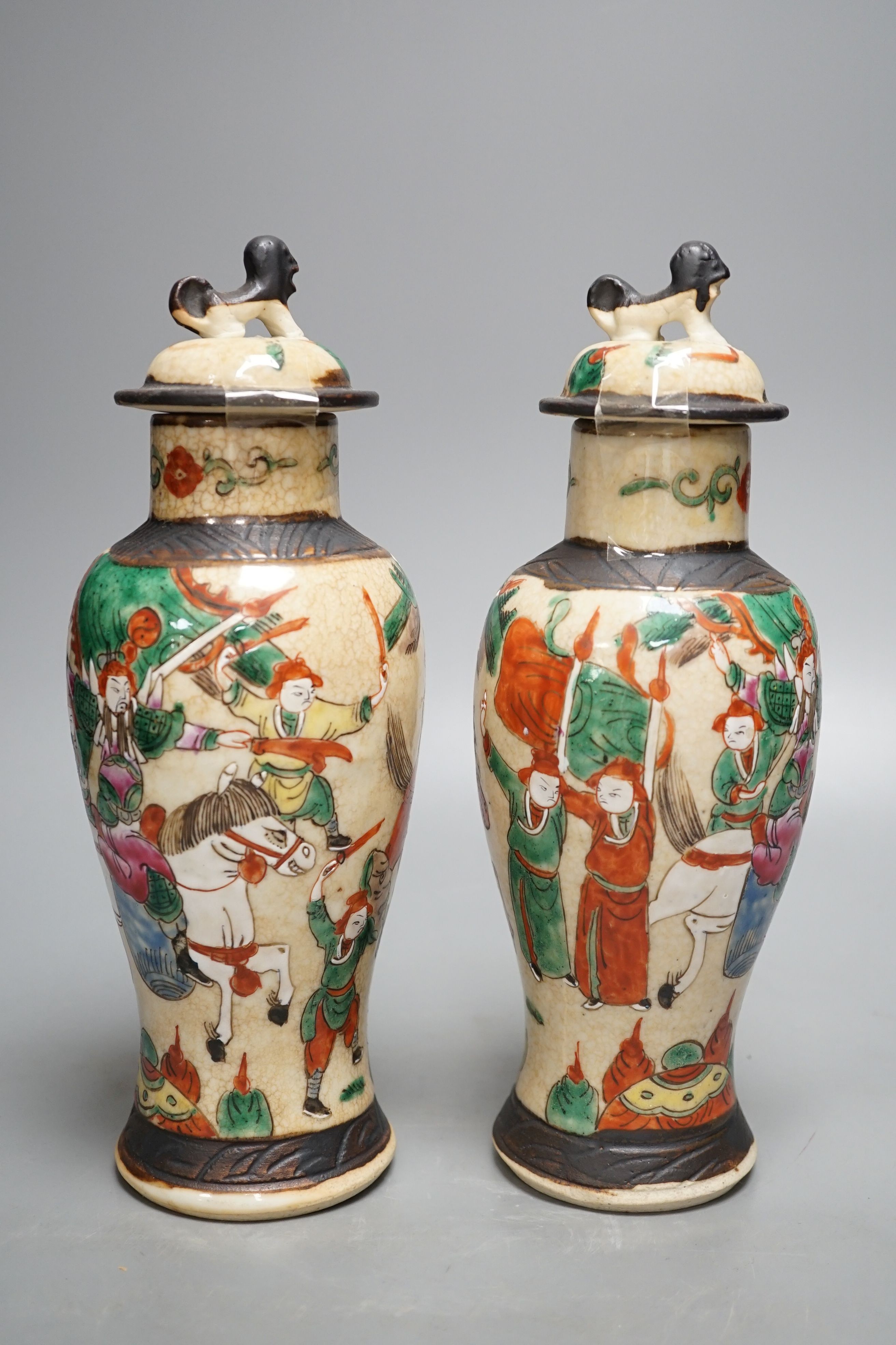 A pair of Chinese famille rose crackle glaze baluster jars and covers, 27cm.